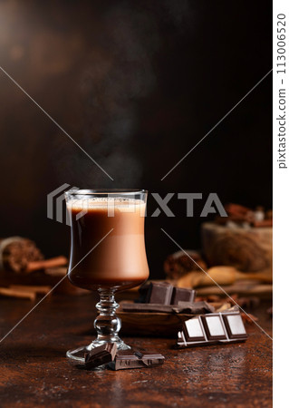 Glass of cocoa drink and pieces of dark chocolate. 113006520