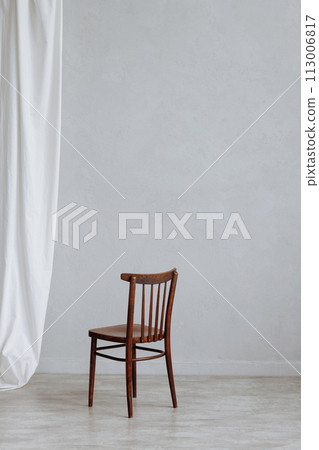 Conceptual empty wooden chair on white wall background and with copy space Conceptual empty wooden chair on white wall background and with copy space 113006817