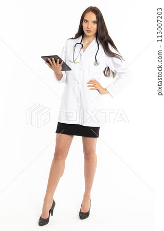 A doctor with a tablet in hand and a stethoscope on her neck wearing a white hospital apron checks the test results. A doctor with a tablet in hand and a stethoscope on her neck wearing a white hospital apron checks the test results. 113007203