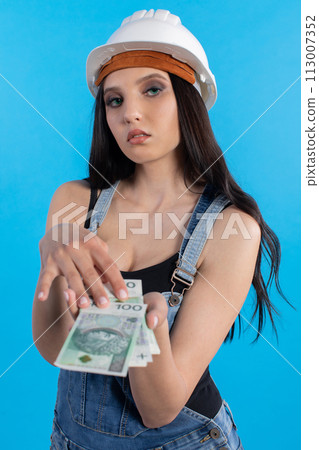 A young construction manager distributes banknotes to everyone who starts working together. A young construction manager distributes banknotes to everyone who starts working together. 113007352