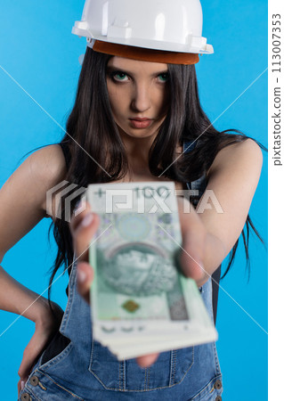 A young construction manager distributes banknotes to everyone who starts working together. A young construction manager distributes banknotes to everyone who starts working together. 113007353
