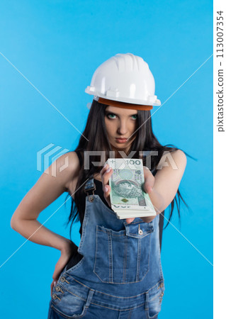 A young construction manager distributes banknotes to everyone who starts working together. A young construction manager distributes banknotes to everyone who starts working together. 113007354