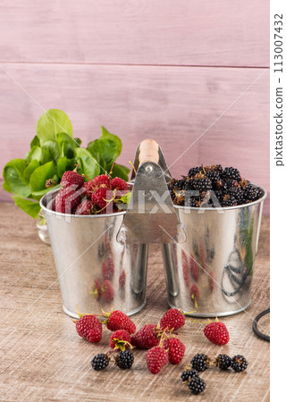 Metal buckets with fresh berries 113007432