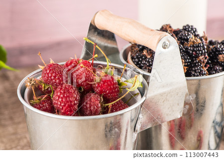 Metal buckets with fresh berries 113007443