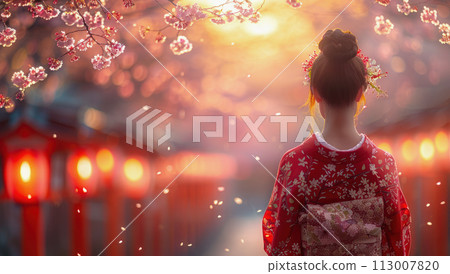 A woman in a red kimono stands under cherry blossom trees 113007820