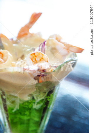 Glass with shrimp cocktail in white sauce Glass with shrimp cocktail in white sauce 113007944