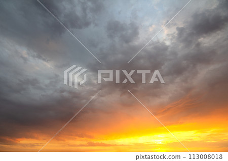 Sunset sky covered with orange puffy clouds in the evening. 113008018