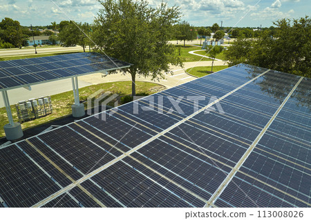 Solar panels installed over parking lot for parked cars for effective generation of clean energy Solar panels installed over parking lot for parked cars for effective generation of clean energy 113008026