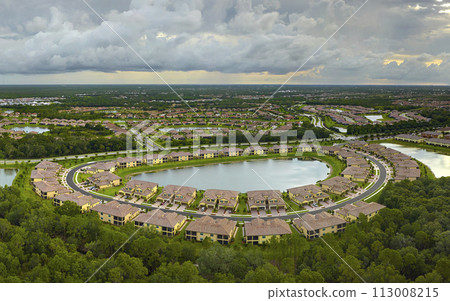 Aerial view of tightly located family houses in Florida closed suburban area. Real estate development in american suburbs 113008215