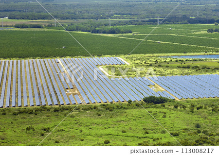 Aerial view of sustainable electrical power plant between agricultural farmlands with photovoltaic panels for producing clean electric energy. Concept of renewable electricity with zero emission 113008217