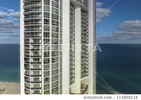 Aerial view of Sunny Isles Beach city with luxurious highrise hotels and condos on Atlantic ocean shore. American tourism infrastructure in southern Florida 113008218