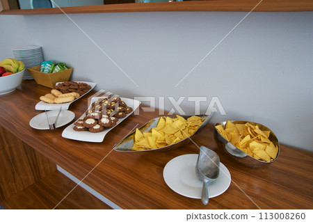 BRESLAU, POLAND - 15 JUN 2018: Offers of various snacks such as crisps in the executive lounge of a luxury hotel 113008260