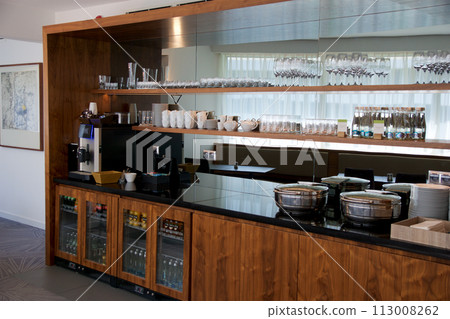 BRESLAU, POLAND - 15 JUN 2018: Buffet without food but with refrigerators with soft drinks and a coffee machine in an executive lounge of a luxury hotel BRESLAU, POLAND - 15 JUN 2018: Buffet without food but with refrigerators with soft drinks and a coffee machine in an executive lounge of a luxury hotel 113008262
