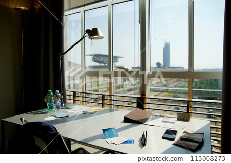TURIN, ITALY - 13 SEP 2019: Desk in a hotel room with a view of the former Fiat car factory Lingotto in Turin TURIN, ITALY - 13 SEP 2019: Desk in a hotel room with a view of the former Fiat car factory Lingotto in Turin 113008273