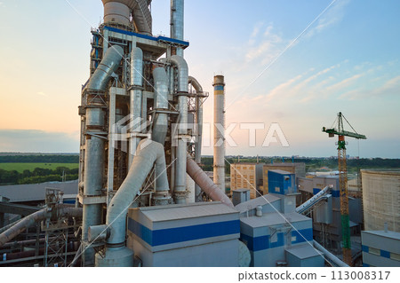 Aerial view of cement factory with high concrete plant structure and tower crane at industrial production site. Manufacture and global industry concept 113008317