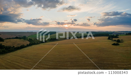 Aerial landscape view of yellow cultivated agricultural field with ripe wheat on bright summer evening 113008343