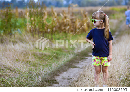 Portrait of little fashionable girl in green sunglasses outdoors Portrait of little fashionable girl in green sunglasses outdoors 113008595