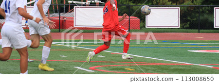 Soccer players chasing a bouncing soccer ball Soccer players chasing a bouncing soccer ball 113008650