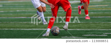 Soccer player dribbling the ball from behind Soccer player dribbling the ball from behind 113008651