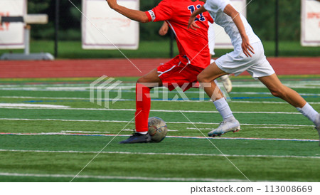 Two boys playing soccer during a game Two boys playing soccer during a game 113008669