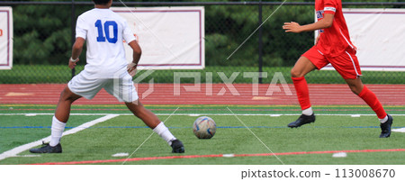 Two boys running to the soccer ball during a soccer match. Two boys running to the soccer ball during a soccer match. 113008670