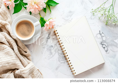 Flat lay with copy space of empty notebook on the table and flowers and a cup of coffee on a light background Flat lay with copy space of empty notebook on the table and flowers and a cup of coffee on a light background 113008874