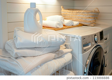 Stack of clean towels on modern washing machine with blurred background. The towels showcasing their soft and fluffy textures 113008886