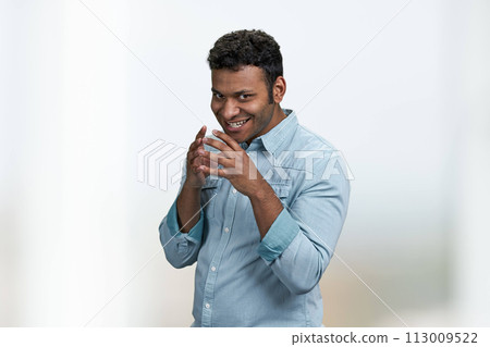 Cunning young man wearing blue shirt thinking about the adventure. Handsome cunning man having a plan. Cunning young man wearing blue shirt thinking about the adventure. Handsome cunning man having a plan. 113009522