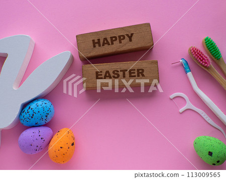 Wooden toothbrushes with Easter decorations on pink background 113009565