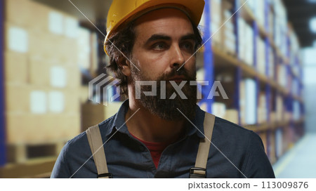 Export manager carrying packages from racks, preparing to ship orders for transportation. Depot employee taking boxes to quality control department, working on shipment and inventory management. Export manager carrying packages from racks, preparing to ship orders for transportation. Depot employee taking boxes to quality control department, working on shipment and inventory management. 113009876