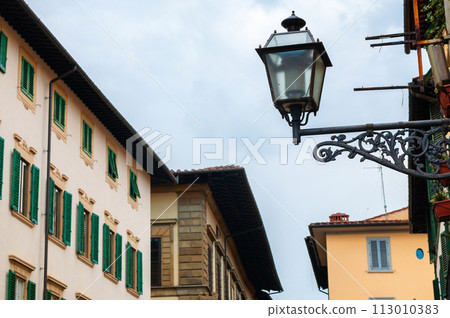 Old vintage style street lamp hanging at the street in city. Light lamp 113010383