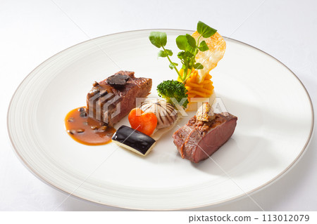 Main beef steak of the French course, fashionable presentation stock image Main beef steak of the French course, fashionable presentation stock image 113012079