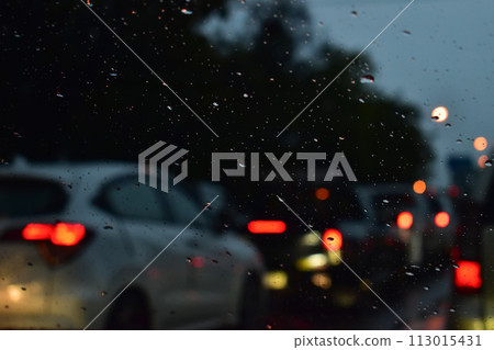 traffic jam on the road in night with rain, defocused background traffic jam on the road in night with rain, defocused background 113015431