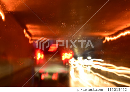 light of car on road in the night, blurred traffic jam background with rain light of car on road in the night, blurred traffic jam background with rain 113015432