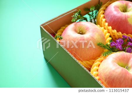 beautiful pink apple in the box on green background beautiful pink apple in the box on green background 113015437