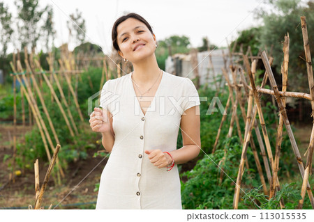 Proud farmer girl at her countryside home. 113015535