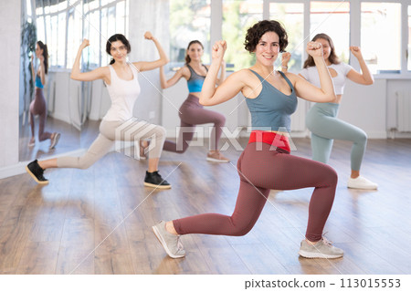 Female teacher conducts modern dance lessons for group of girls Female teacher conducts modern dance lessons for group of girls 113015553