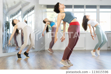 Group of women dancing hip hop in studio Group of women dancing hip hop in studio 113015596