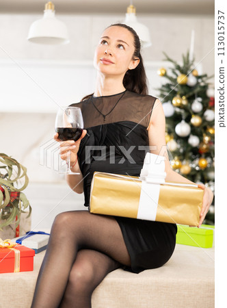 positive woman in the new year atmosphere sits on table. 113015737