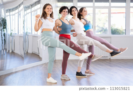 Group of girls with middle-aged woman perform Irish folk dance Group of girls with middle-aged woman perform Irish folk dance 113015821