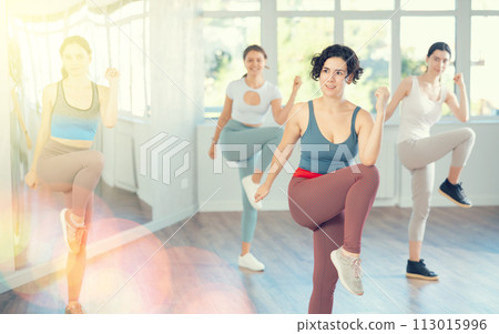 Female teacher conducts modern dance lessons for group of girls Female teacher conducts modern dance lessons for group of girls 113015996