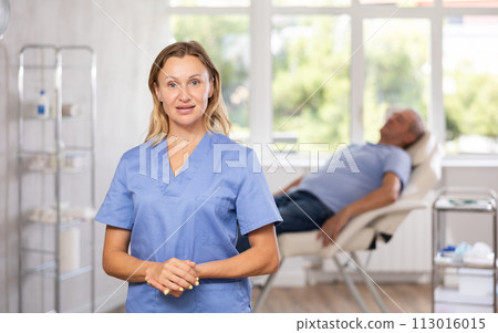 Confident professional female doctor standing in medical office Confident professional female doctor standing in medical office 113016015