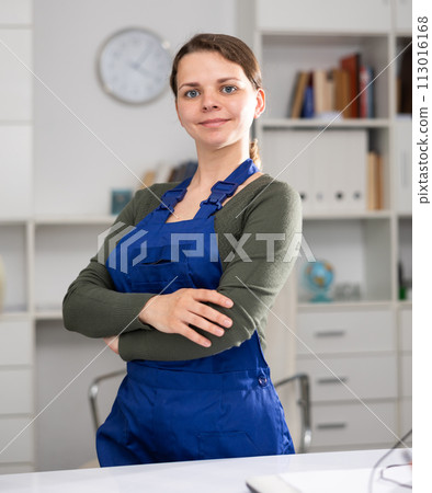 Female office cleaner is satisfied after cleaning in office 113016168