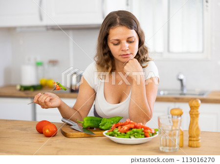 Female eating healthy salad with fresh vegetable 113016270