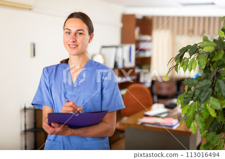 Woman doctor wear white medical uniform with folder of documents Woman doctor wear white medical uniform with folder of documents 113016494
