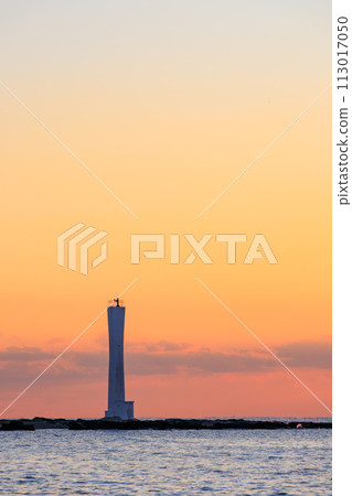 Beautiful sunset and lighthouse silhouette seen from the beach. At Araihama Beach, Miura City, Kanagawa Prefecture, Japan. 202 Beautiful sunset and lighthouse silhouette seen from the beach. At Araihama Beach, Miura City, Kanagawa Prefecture, Japan. 202 113017050