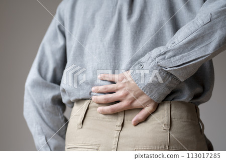 Man with back pain, body parts, faceless, back view 113017285