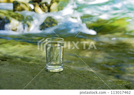 Natural water poured into a glass 113017462