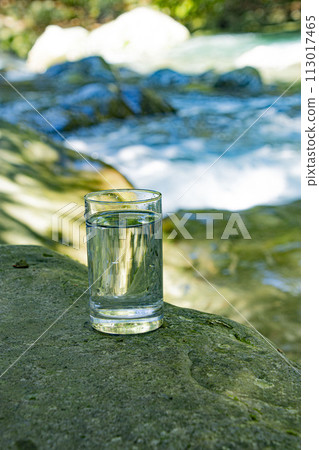 Natural water poured into a glass 113017465