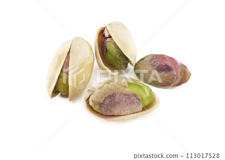 Pistachio nuts in shell isolated on white background Pistachio nuts in shell isolated on white background 113017528